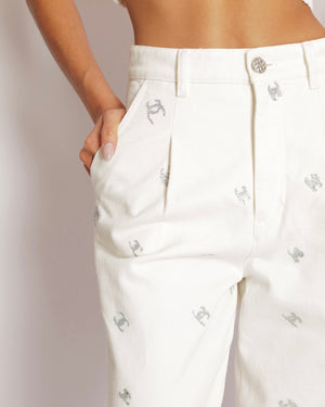 Chanel White Straight Leg High-Waisted Jeans with Turquoise, Lilac, and Silver Metallic CC Logos and Silver Button Detail Size FR 34 (UK 6)