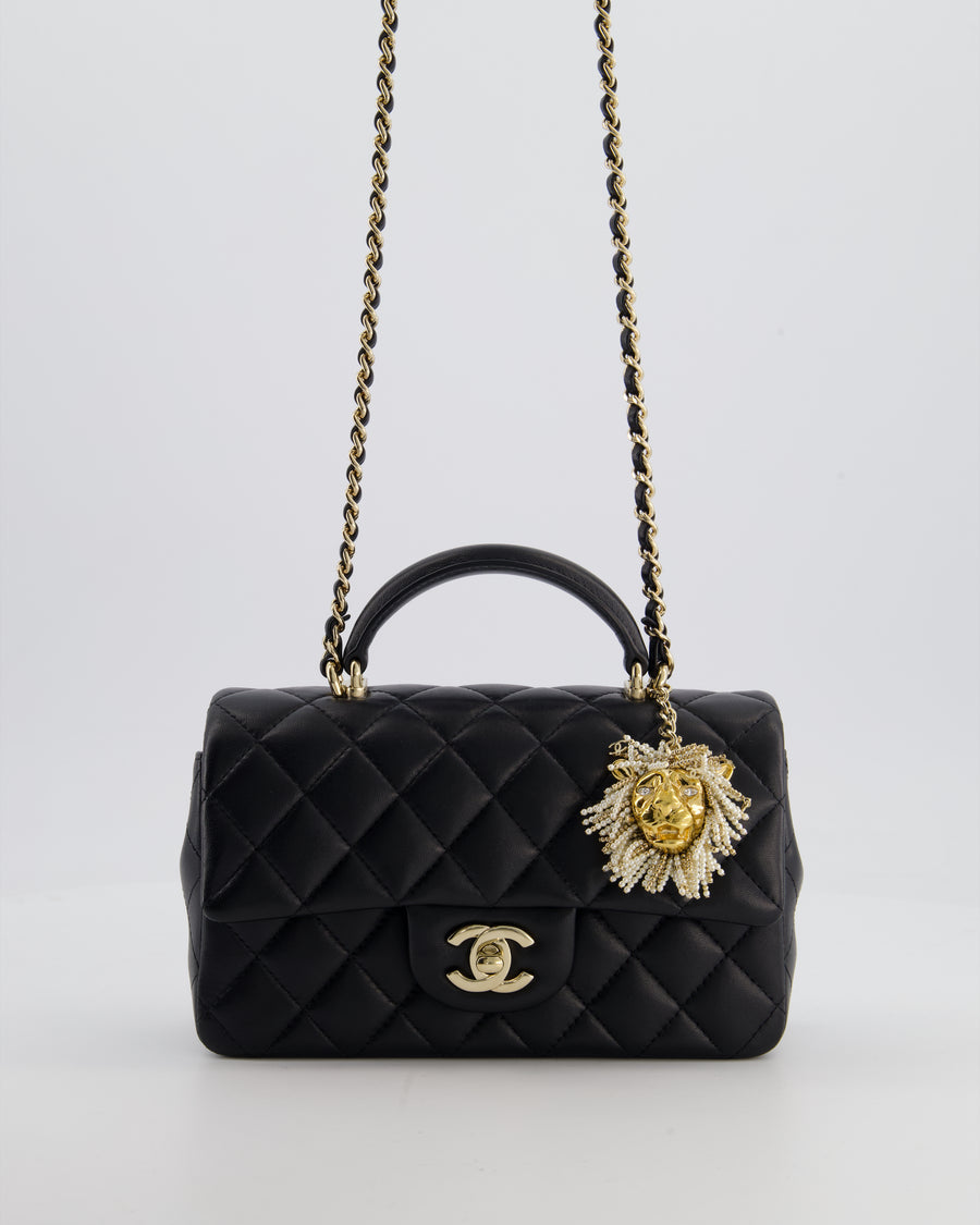 Chanel Black Mini Rectangular Top Handle Flap Bag in Lambskin Leather with Champagne Hardware and Pearl Crystal Lion Charm