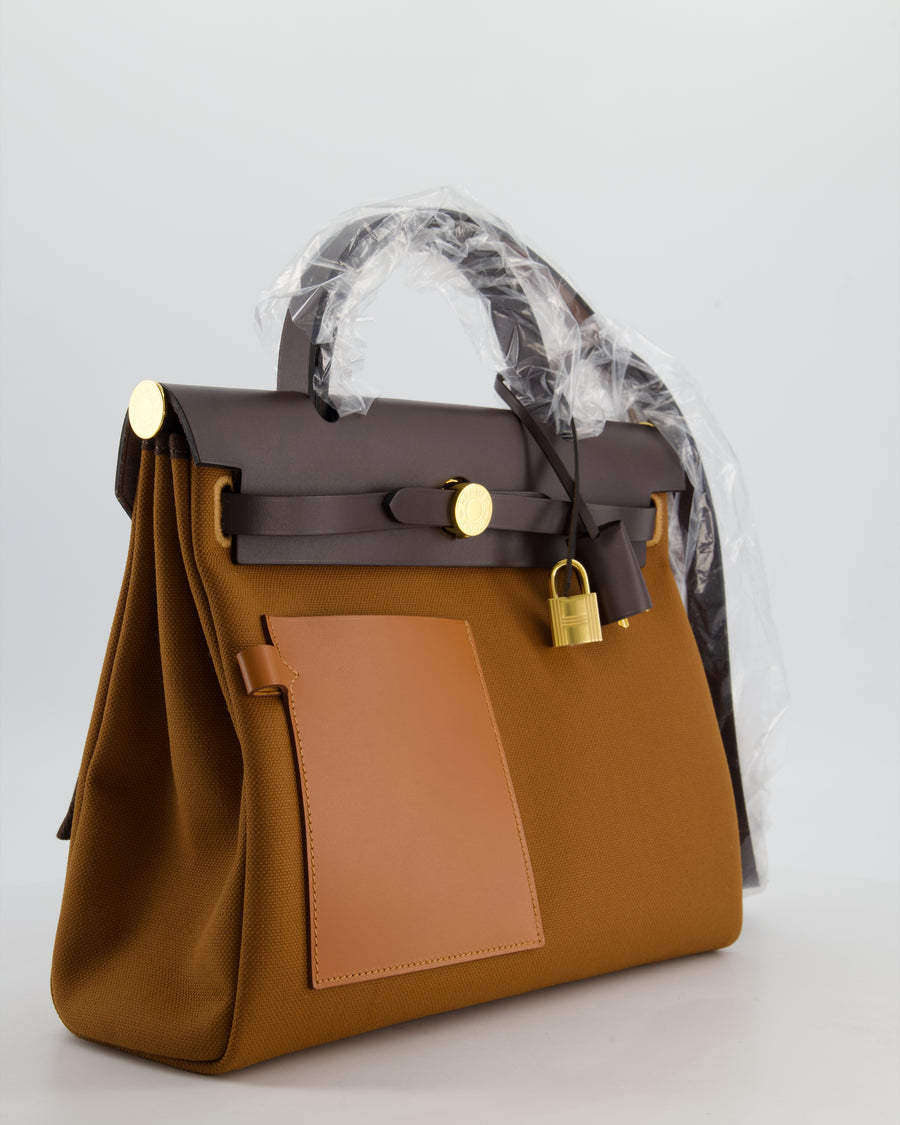 *SUPER HOT* Hermès Herbag 31 Zip Pocket Cargo Bag in Fauve Toile Militaire Canvas, Ebene Vache Hunter Leather with Gold Hardware