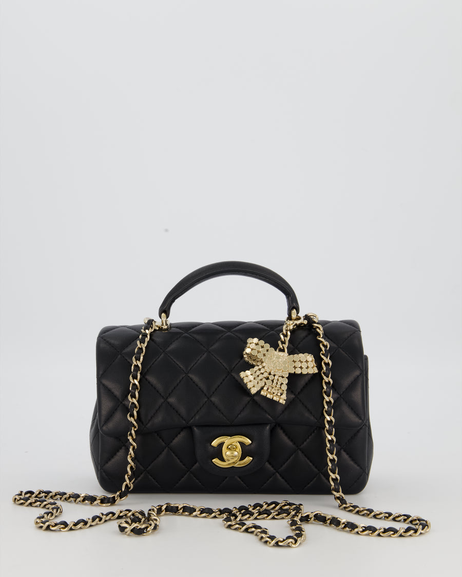 Chanel Black Mini Rectangular Top Handle Flap Bag in Lambskin Leather with Champagne Hardware and Strass Removable Bow Charm