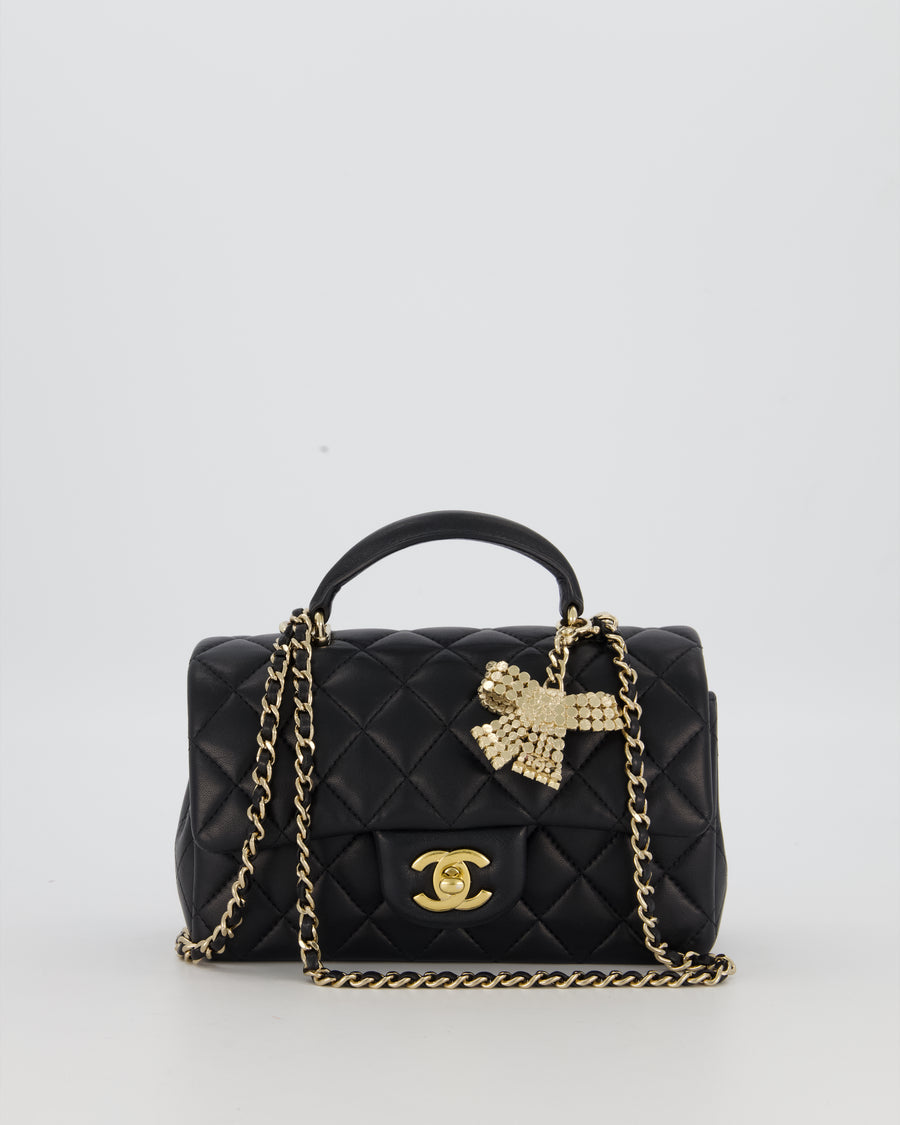 Chanel Black Mini Rectangular Top Handle Flap Bag in Lambskin Leather with Champagne Hardware and Strass Removable Bow Charm