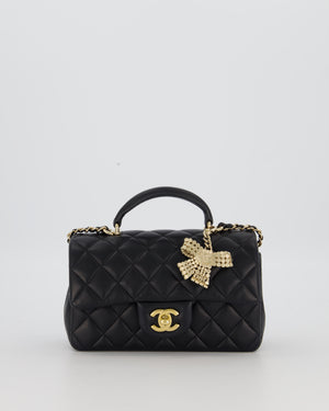 Chanel Black Mini Rectangular Top Handle Flap Bag in Lambskin Leather with Champagne Hardware and Strass Removable Bow Charm