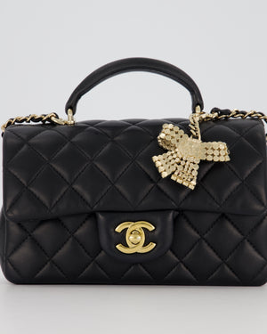 Chanel Black Mini Rectangular Top Handle Flap Bag in Lambskin Leather with Champagne Hardware and Strass Removable Bow Charm