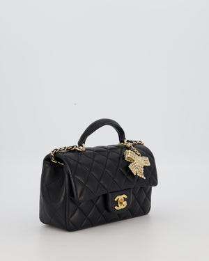 Chanel Black Mini Rectangular Top Handle Flap Bag in Lambskin Leather with Champagne Hardware and Strass Removable Bow Charm